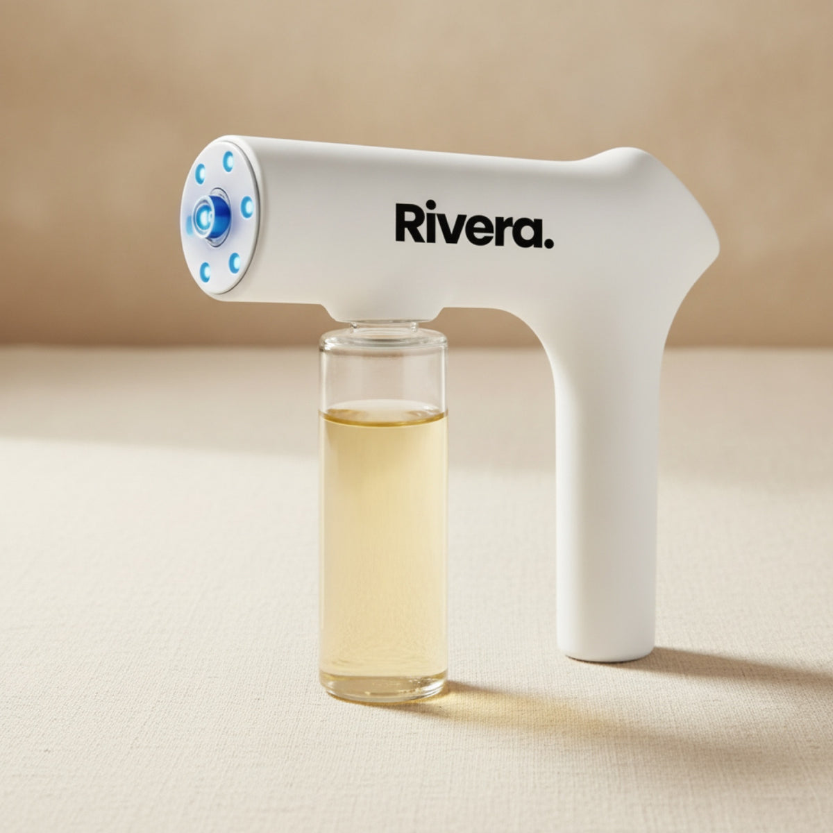 Rivera Odor Gun cordless enzyme mister on a cream linen surface
